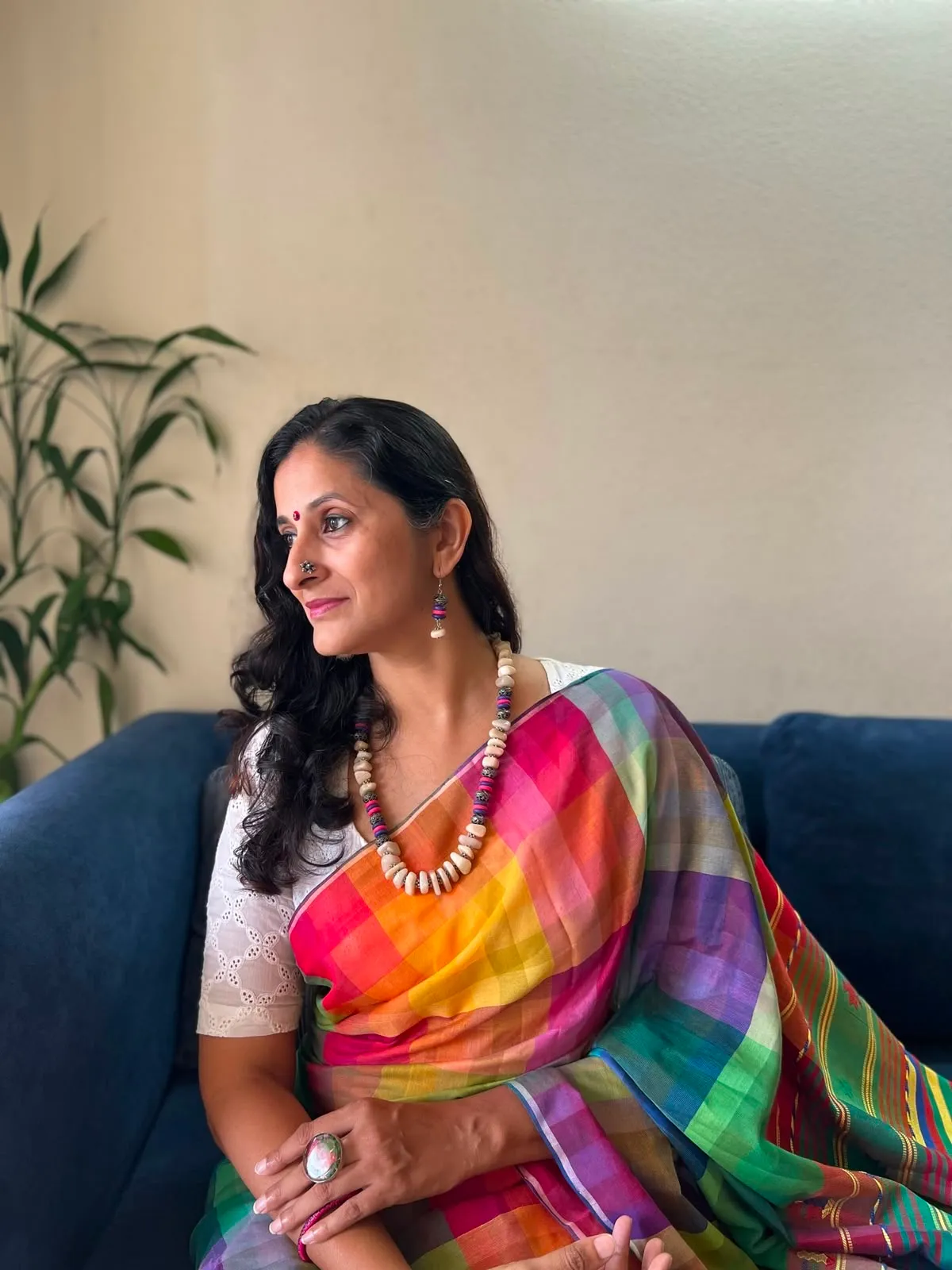 Renu wearing a rainbow-striped handloom saree